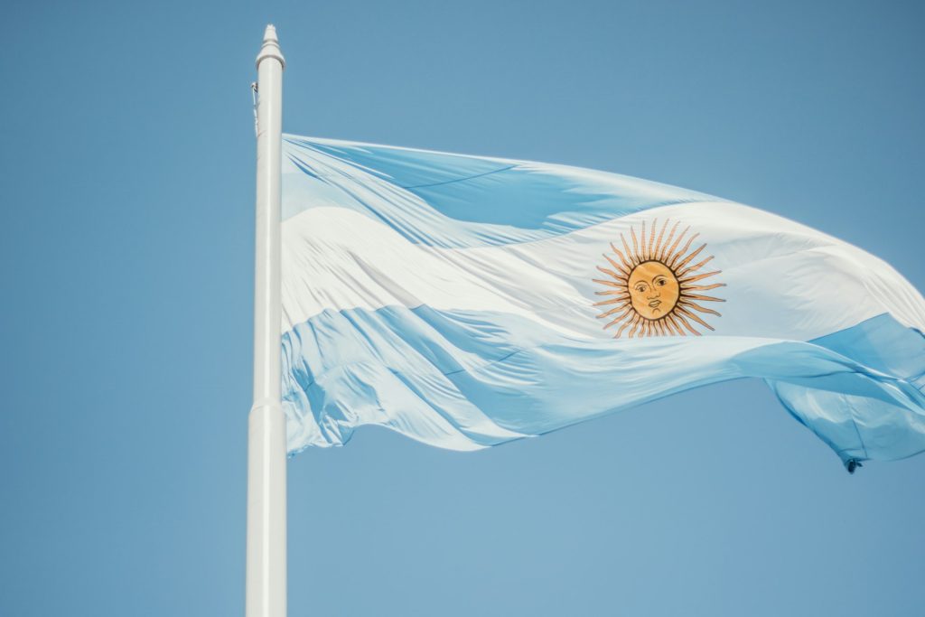 Argentine flag waving against a blue sky